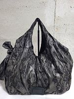 Front view of black lace Valentino Nuage hobo bag with side bow