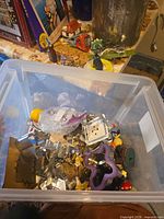 Top view of tote showing many metal cookie cutters, purple cutter, figurines and parts