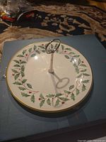 Top view of porcelain cake stand showing holly pattern and handle