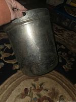 Full view of galvanized canister held in hand