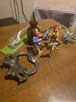 Group shot showing figurines, bottle and hardware pieces