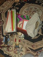 Lot overview showing candles, figurines, pouch, textile, box and frame