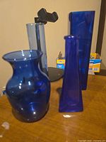 Group shot showing all three cobalt blue glass vases in assorted shapes