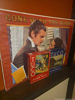 Overall lot: Gone With The Wind poster behind two TUCO puzzle boxes
