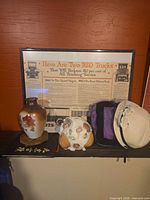 Group shot of poster, vase, shell ornament, two hats, textile