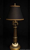 Overall view of brass and marble table lamp with staging shade