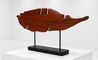 Front view of entire wood sculpture on stand