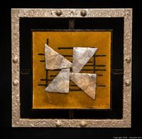 Front view of square mixed-media wall art showing frame, amber panel, and geometric metal elements