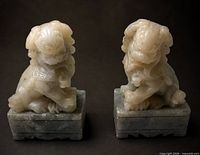 front view of both stone Foo Dogs on plinths