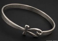 Full view of sterling silver bangle showing infinity cross detail