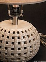 Close-up of woven ceramic lattice body and brushed metal column