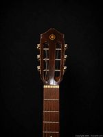 Headstock showing Yamaha logo, slotted design, gold-tone tuners