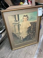 Full view of framed portrait showing frame, mat and subject