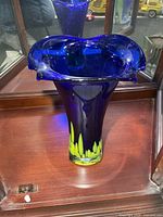 Full view of cobalt blue art glass vase inside display cabinet