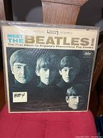 Front cover of Meet The Beatles! LP in plastic sleeve