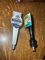 Front view of both tap handles showing logos and full length