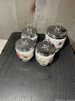 Four egg coddlers showing size difference and lid style