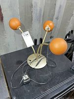 Full view of lamp with three orange globes and wiring