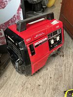 Front left view showing Honda EX1000 labeling, handle, vents