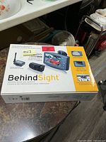 Front of sealed BehindSight backup camera box showing contents and branding