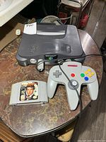 Top view of Nintendo 64 console, controller and game cartridge on table