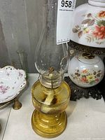 Full view of amber glass oil lamp with chimney