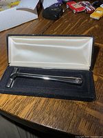 Razor resting in open case, full view