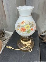 Front view of milk glass floral table lamp showing entire piece