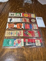 Plastic sleeve with eight vintage matchbook covers visible