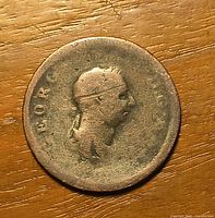 Obverse of coin showing worn bust of George III