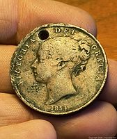 Obverse view showing Victoria bust, legend, date 1854, hole near rim
