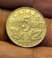 Reverse side showing denomination, maple leaves, year 1932