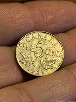 Reverse side showing CANADA FIVE CENTS, maple leaves, date 1934
