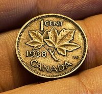 Reverse showing two maple leaves, date 1938, denomination 1 CENT, country CANADA, designer initials K·G