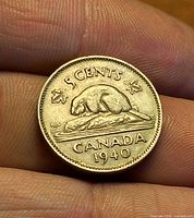 Reverse of 1940 Canadian 5-cent coin showing beaver on rock, 5 CENTS legend and date