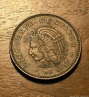 Obverse of 1957 Mexico 50 centavos coin on flat surface