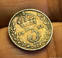 Reverse of 1919 threepence showing crown over 3 and date within wreath