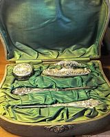 Open case showing all four sterling grooming tools and powder jar