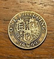 Reverse showing ONE SHILLING legend, shield design and date 1899