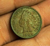 Obverse of 1906 Indian Head Cent showing green toning and date