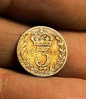 Reverse of 1912 threepence coin showing crowned 3 and date