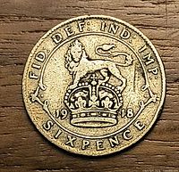 Reverse view showing lion on crown, date 1918, legends FID DEF IND IMP SIXPENCE