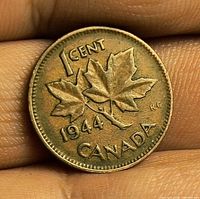 Reverse side of 1944 Canadian 1-cent coin showing maple leaves, date and denomination