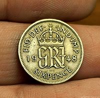Reverse showing crowned GR VI monogram, date 1948, denomination SIXPENCE