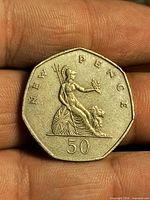 Reverse of UK 50 New Pence coin showing Britannia design and denomination