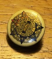 Front of Bakelite button showing emblem and colours