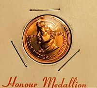 Obverse of copper medallion showing Kennedy portrait and inscriptions