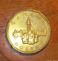 Reverse side showing Parliament Buildings design and CANADA DOLLAR legend