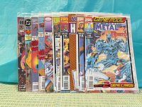 Front view of nine bagged comics showing titles and condition