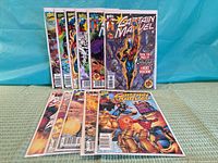 Front view of all 11 bagged Captain Marvel comics displayed upright and laid flat